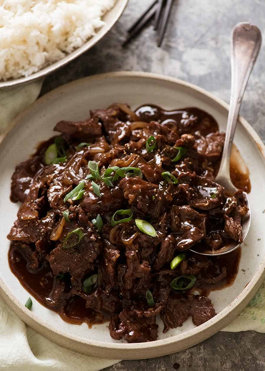 Chinese Honey Pepper Beef on a plate with rice on the side, ready to be served