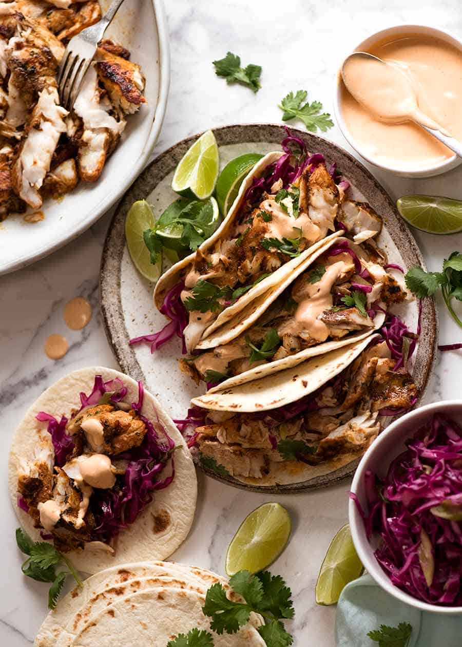 Fish Tacos with sides and toppings - pickled cabbage and fish taco sauce