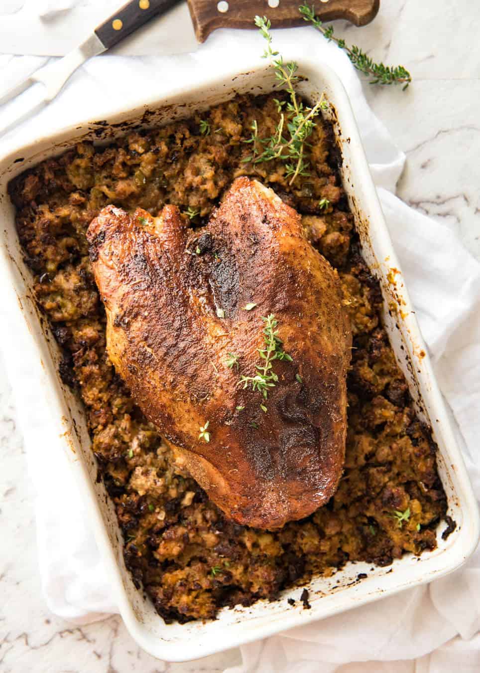 This Cajun dry brined turkey breast is baked in the same roasting pan as the Dressing / Stuffing so it's extra juicy and moist! A chef recipe, this Cajun Baked Turkey Breast with Dressing is easy and spectacular. EPIC ONE PAN COOKING for a Thanksgiving turkey! www.recipetineats.com