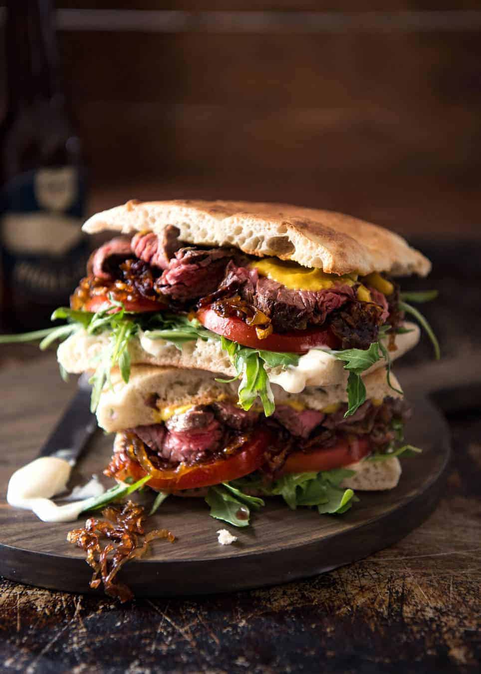 A juicy Steak Sandwich loaded with tender slices of steak, caramelised onion, garlic aioli, lettuce, tomato and mustard. www.recipetineats.com