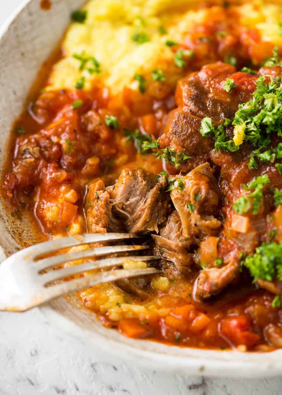 Fork tender veal braised in a rich red sauce, Osso Buco is a meal fit for a king! www.recipetineats.com