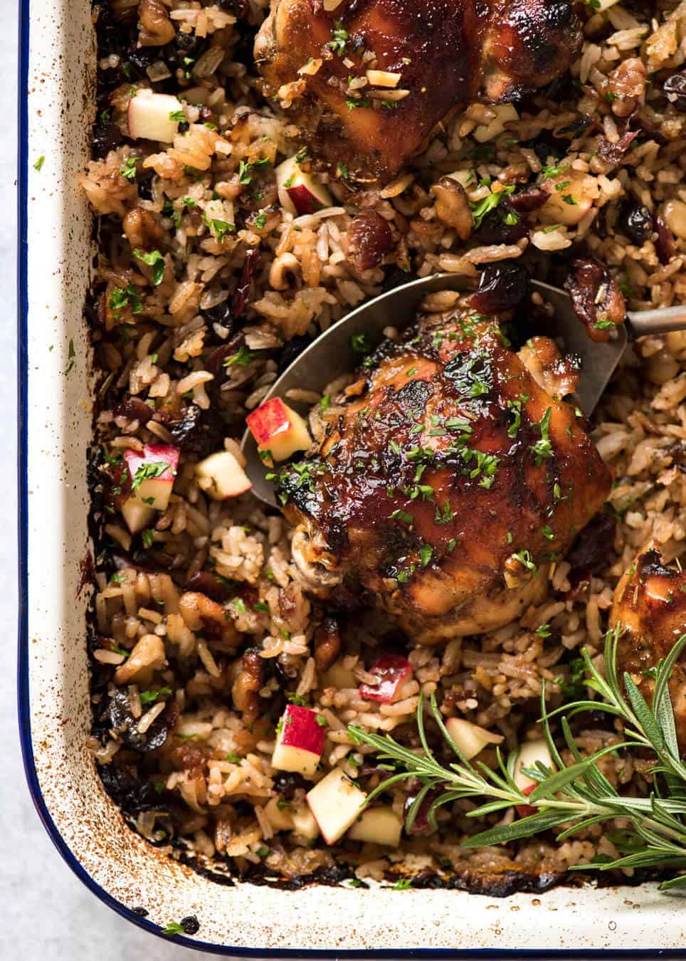 A flavour loaded one-pan, quick midweek dinner - Baked Chicken and Rice Pilaf with Cranberries, Walnuts and Apple. The smell when this is cooking is amazing! www.recipetineats.com