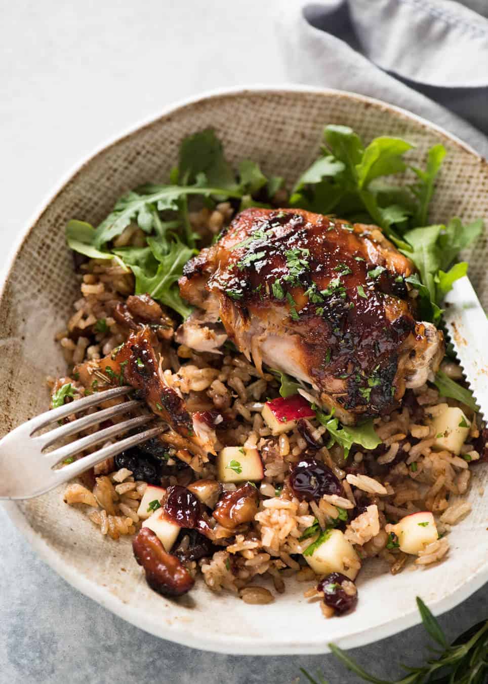 A flavour loaded one-pan, quick midweek dinner - Baked Chicken and Rice Pilaf with Cranberries, Walnuts and Apple. The smell when this is cooking is amazing! www.recipetineats.com