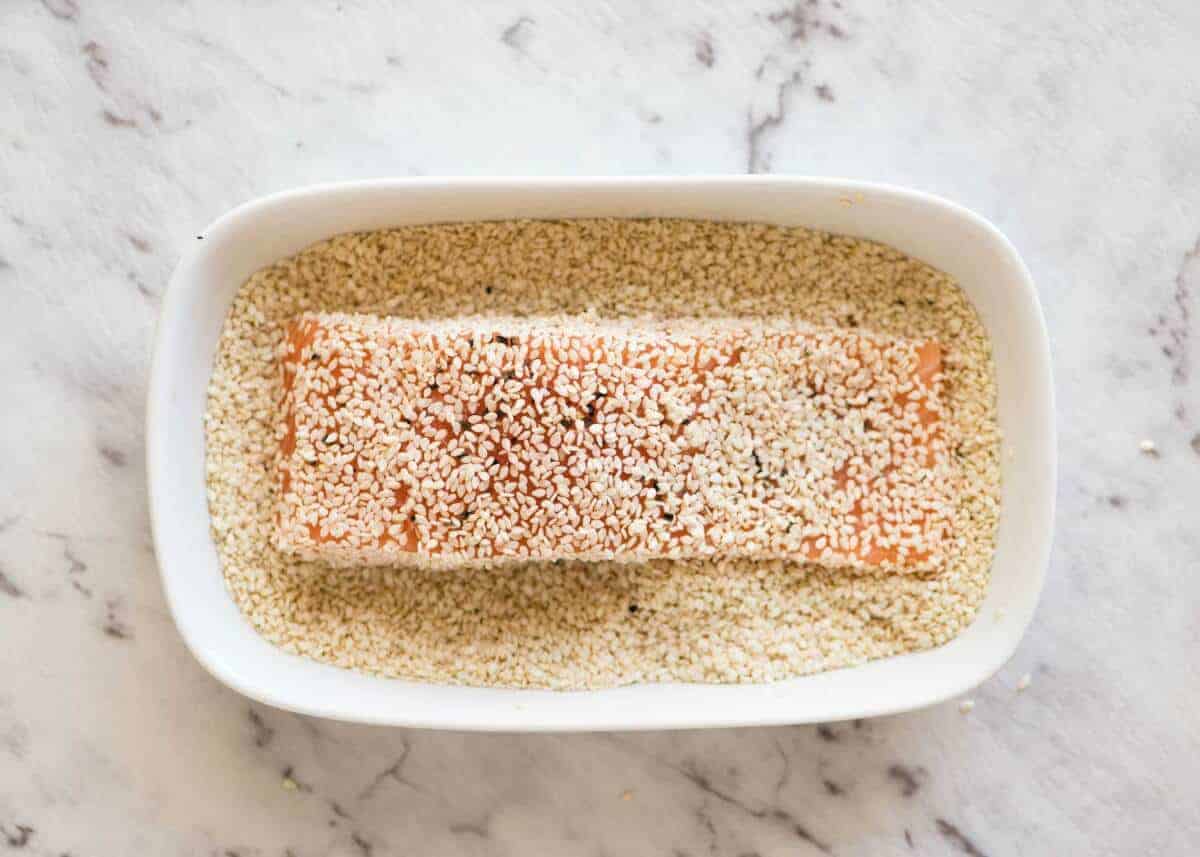 Just roll the salmon in sesame seeds, drizzle with oil and bake! You'll be amazed how well the sesame adheres to the salmon and love how crispy this Sesame Salmon comes out!