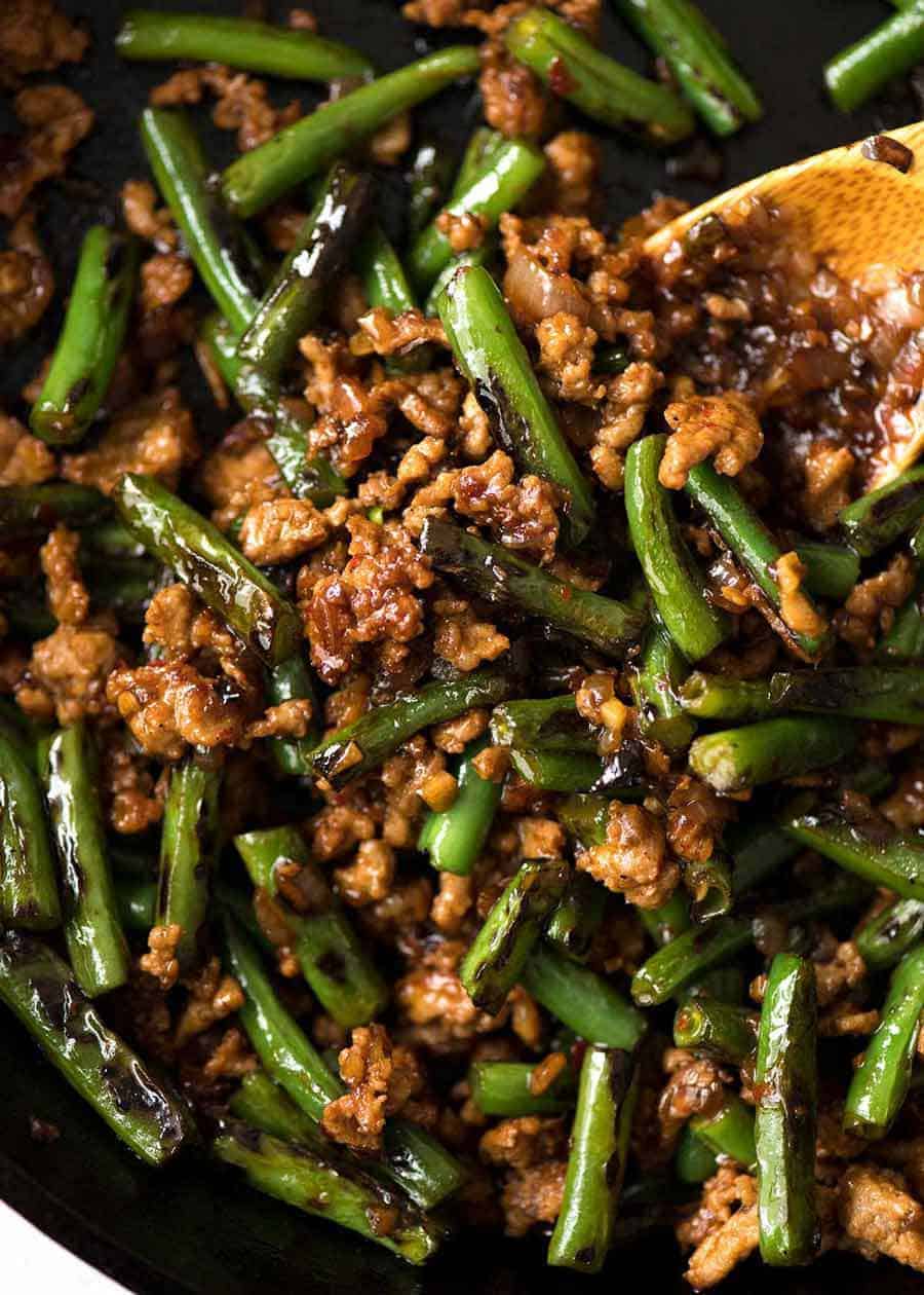 Close up of Pork Stir Fry with Green Beans in a black skillet, fresh off the stove