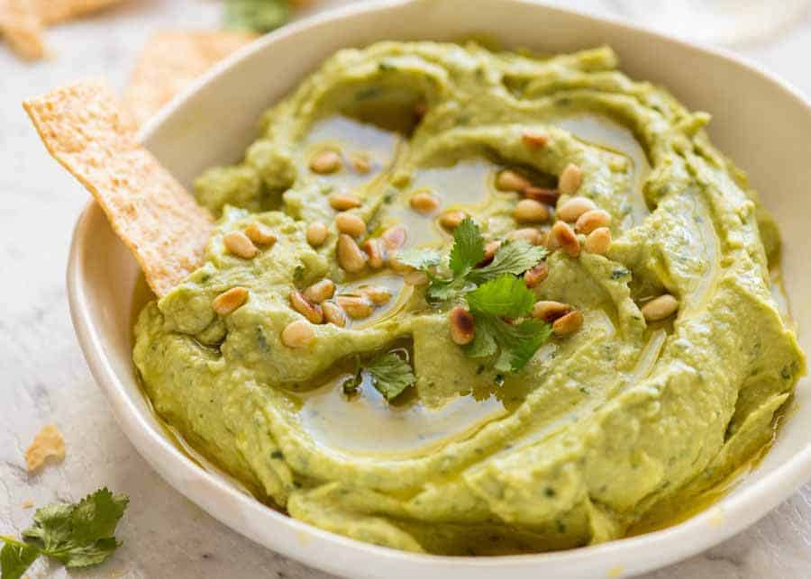 Creamy Avocado Dip in a rustic white dish, ready to be demolished
