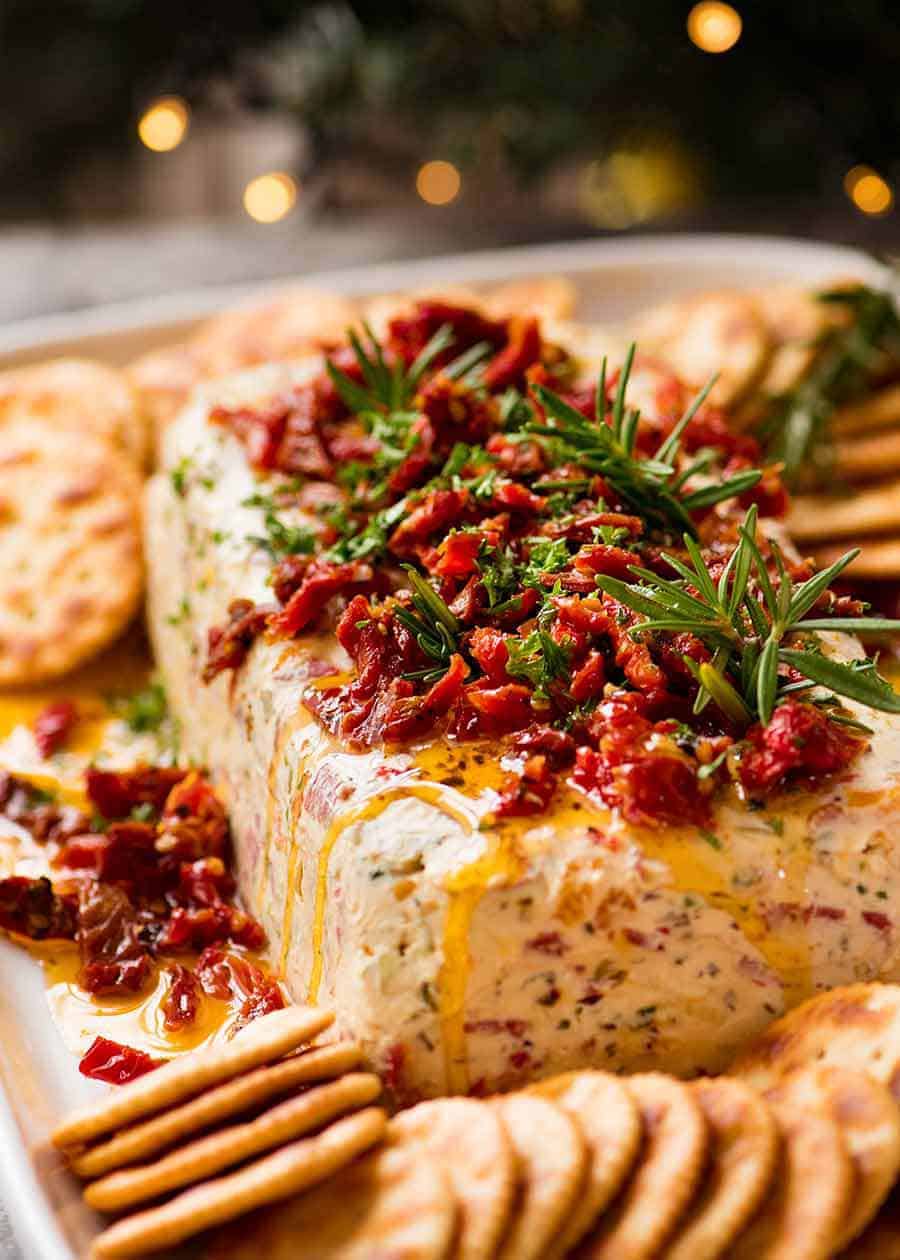 Christmas Appetiser Italian Cheese Log with Christmas tree in background - festive appetizer for the holidays