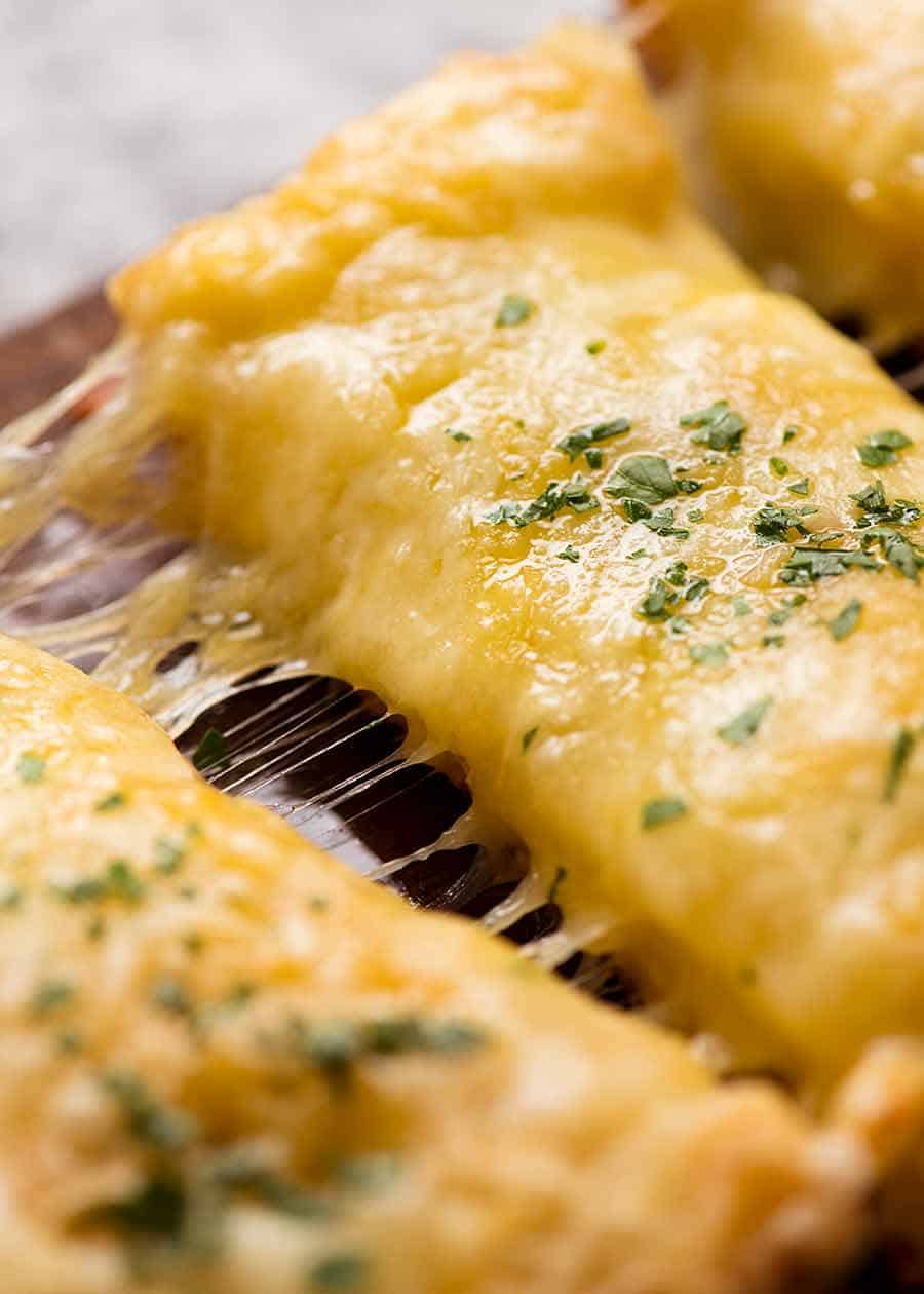 Close up of cut slices of Quick Cheesy Garlic Bread with cheese stretch