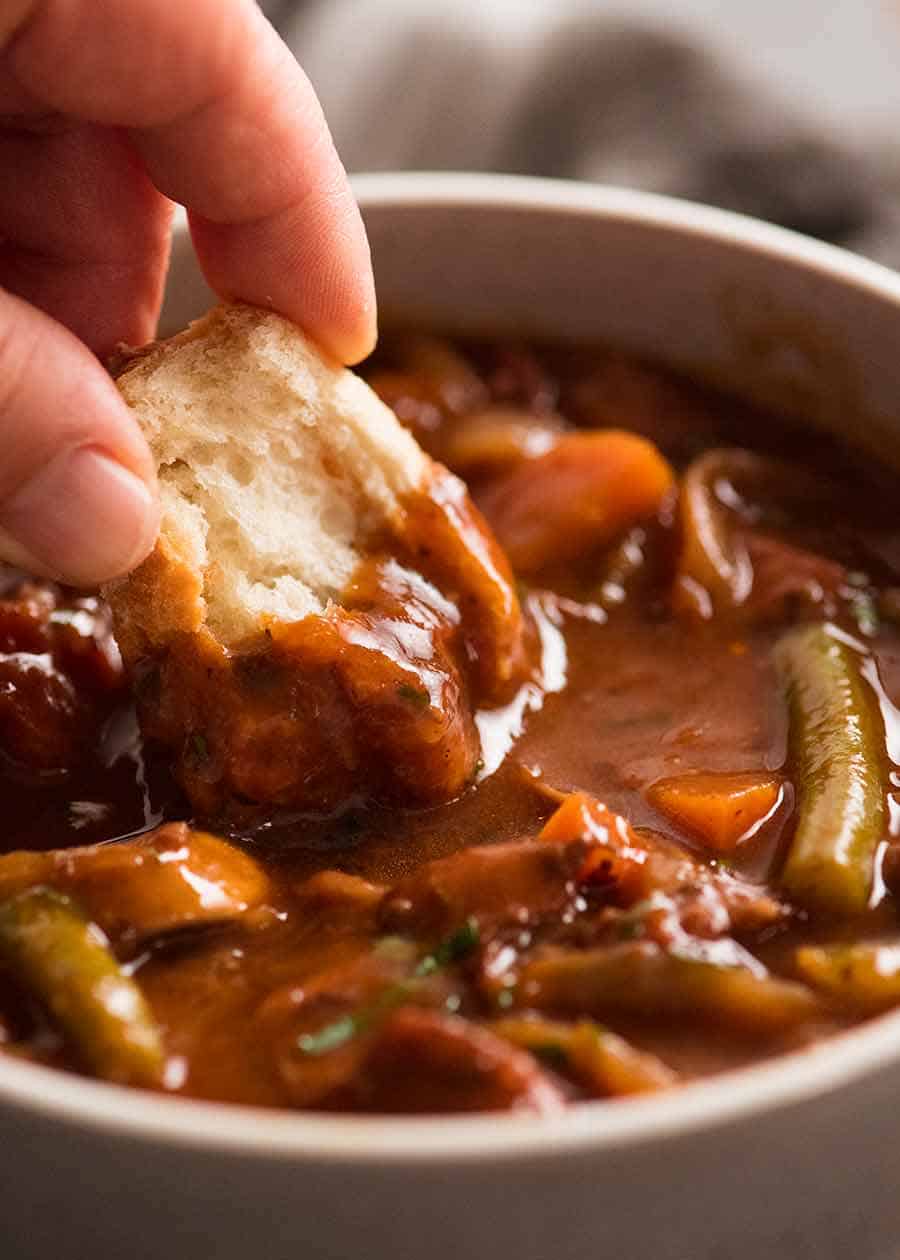 Dipping crusty into Chicken Stew