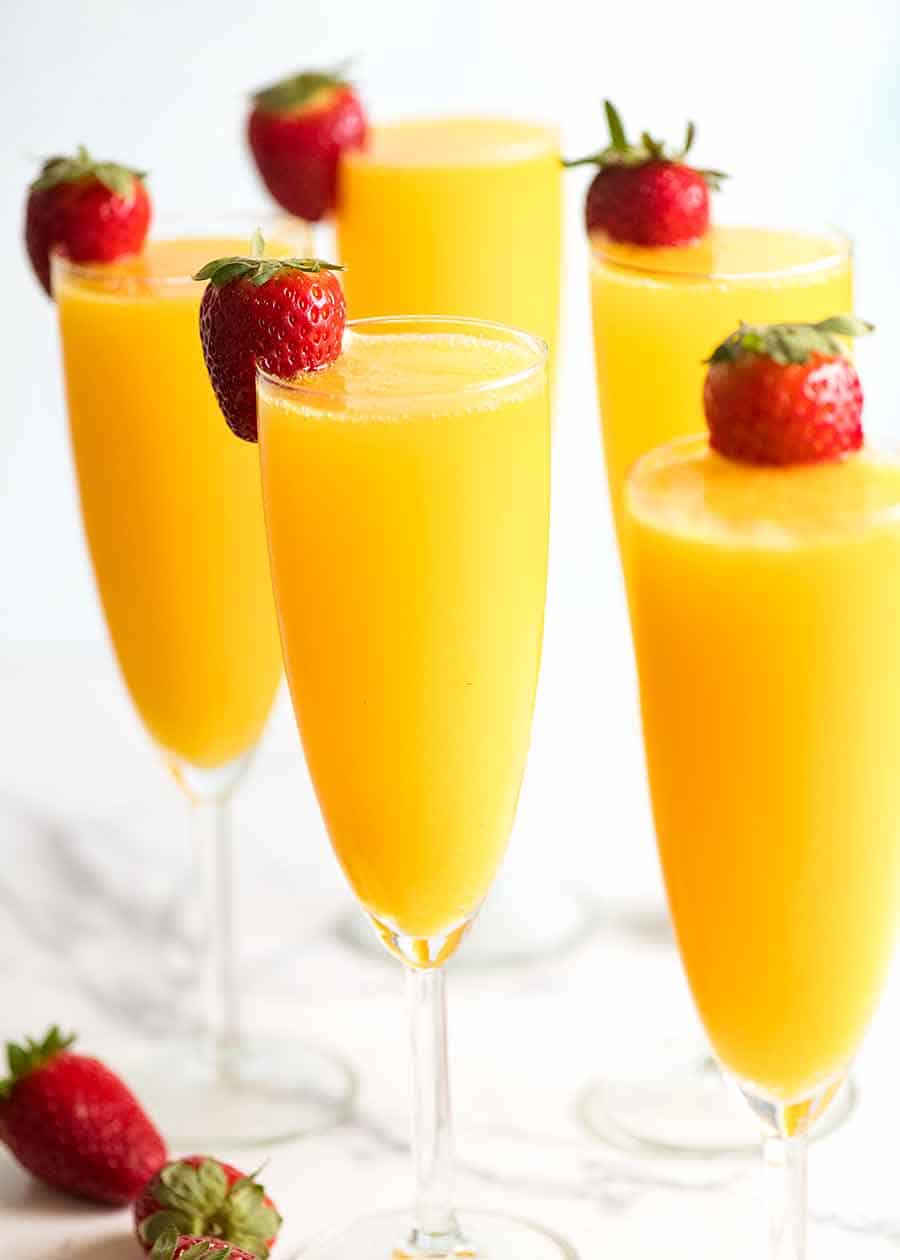 Champagne flutes filled with Mimosas