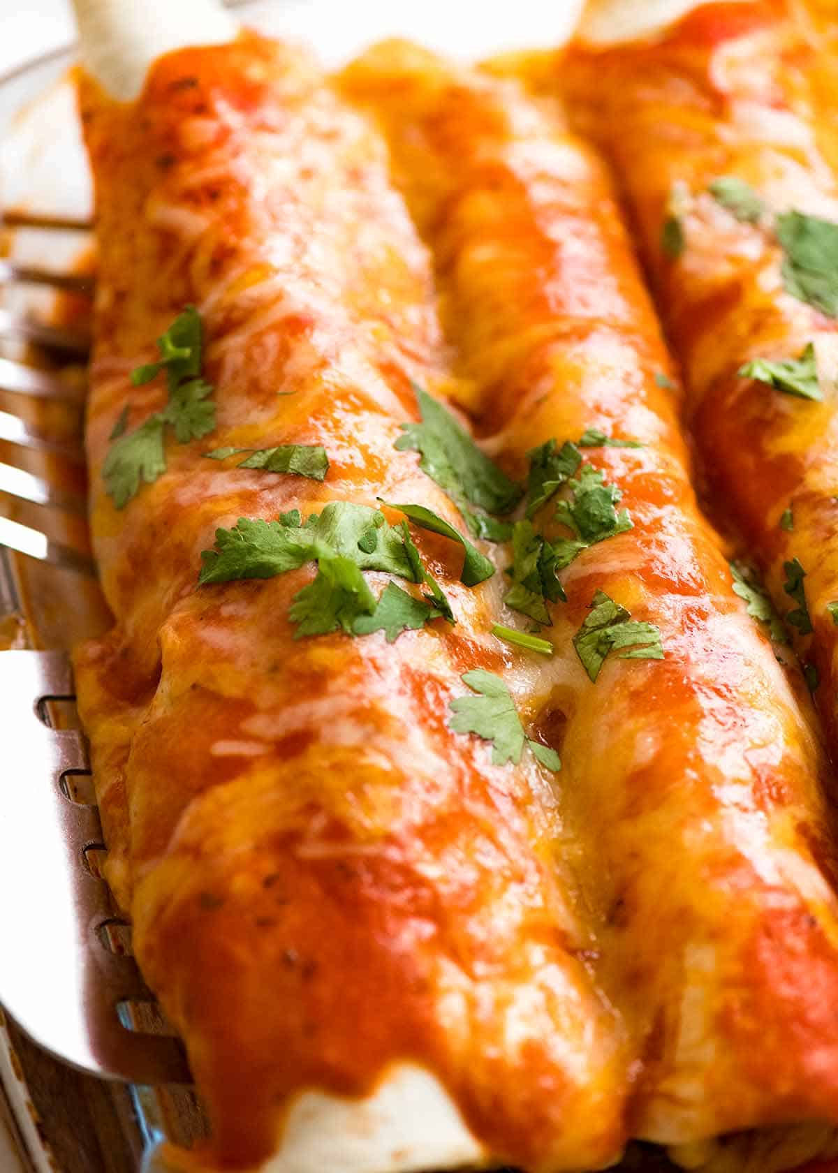 Close up of Chicken Enchiladas in a baking dish, fresh out of the oven